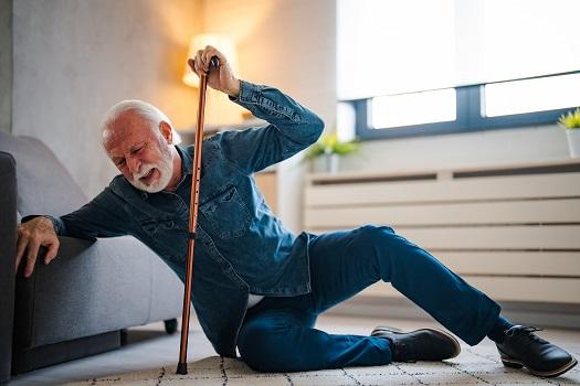 Older adult fallen at home holding a cane — balance and fall prevention therapy in Fort Wayne