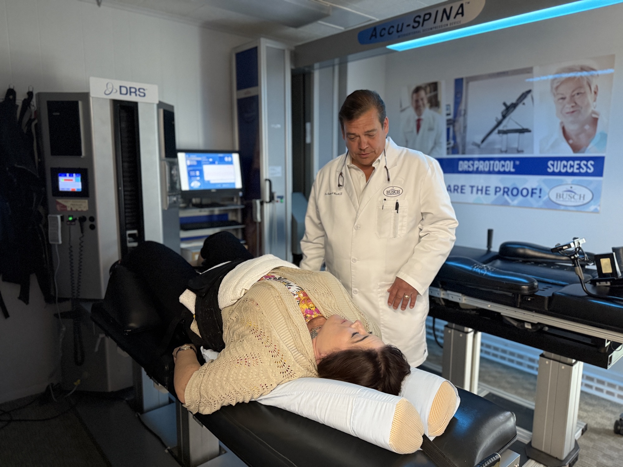 Dr. Busch overseeing a patient's session on the Accu-SPINA® decompression table during a DRS Protocol® treatment